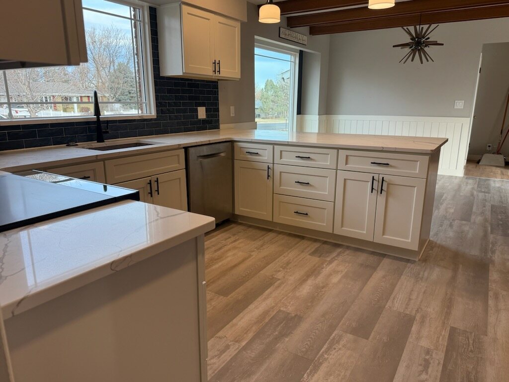 Custom kitchen remodel with white cabinets and LVP flooring in Loveland CO